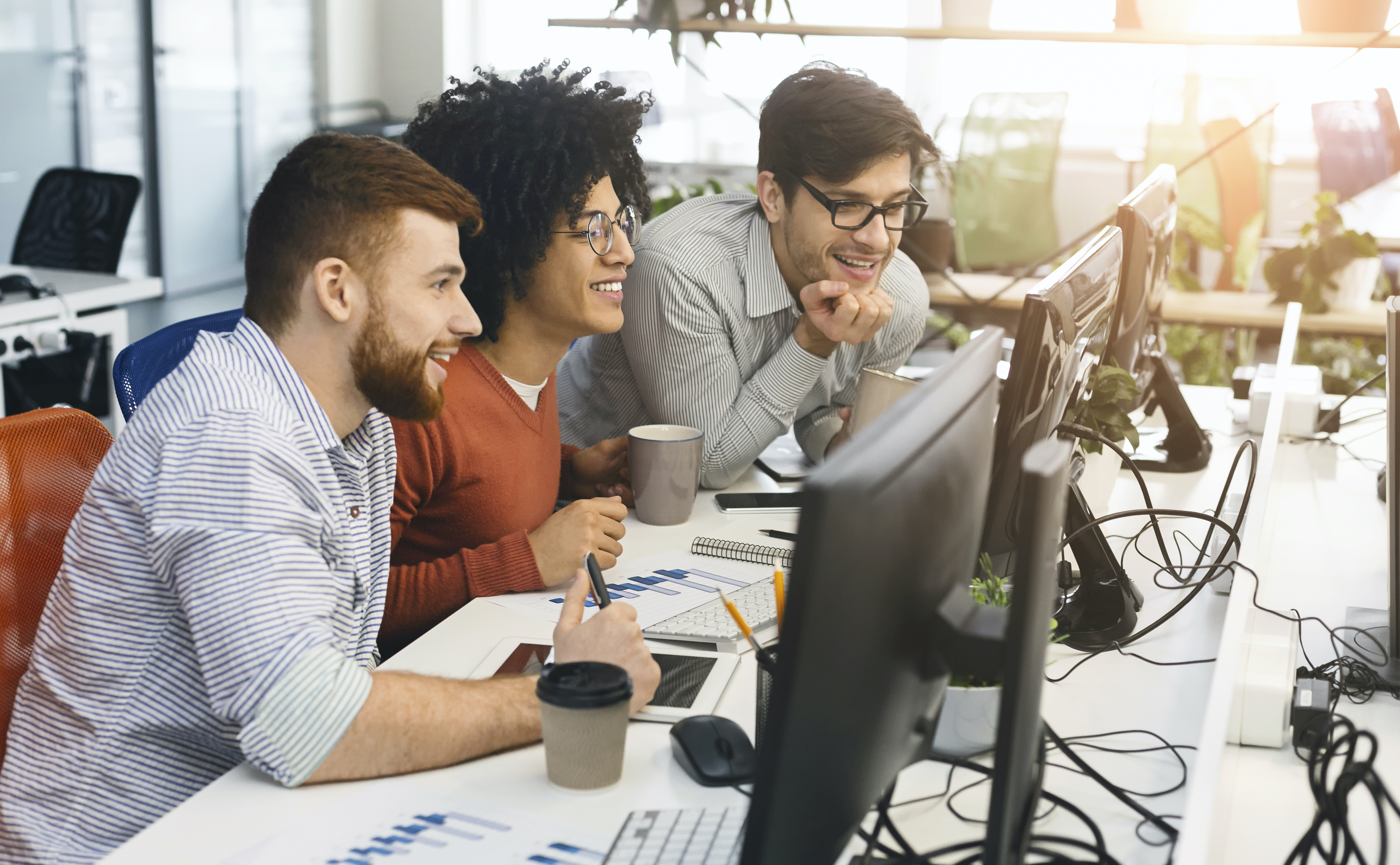 IT company staff in Tampa, Florida work on computers together