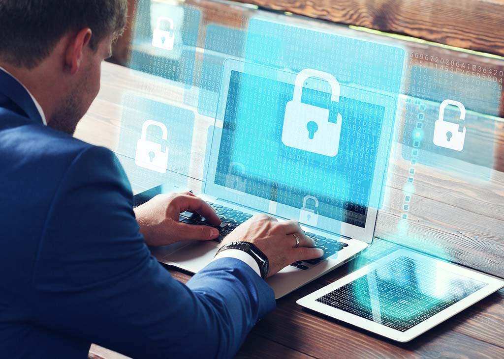 staff sits around table while being trained on cybersecurity weakness by an african american woman