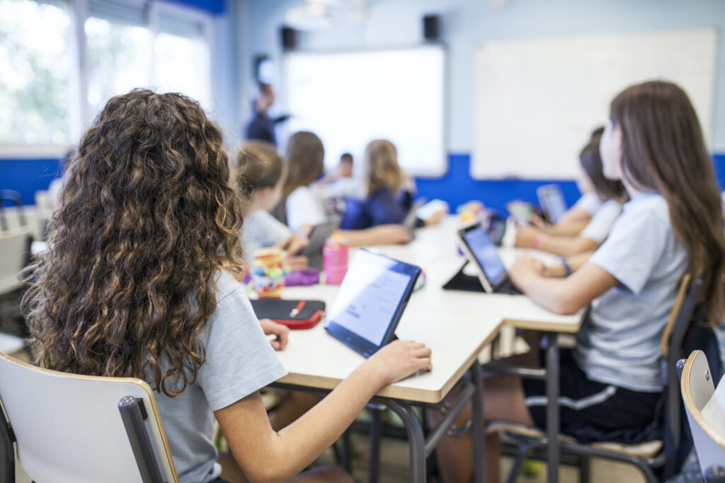 school cybersecurity - middle school students with class ipads